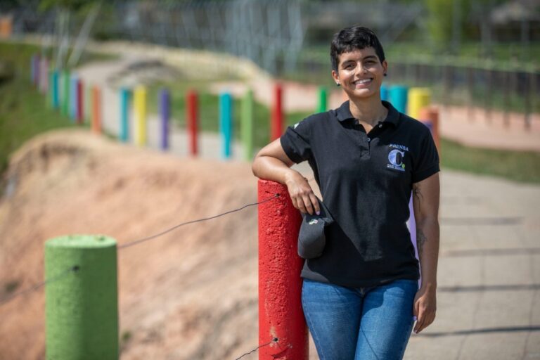 Vanesa smiling at the camera wearing her Press shirt.